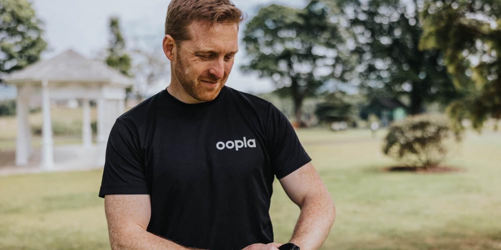 Support to Perform’s CEO Jonny Bloomfield uses his smartwatch to access the Oopla app. 